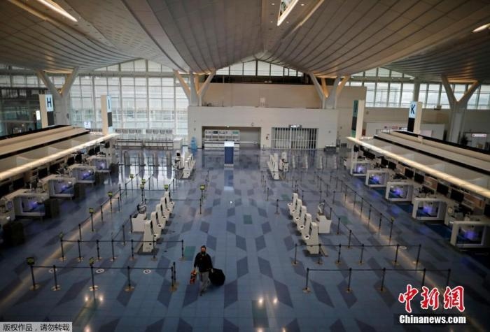資料圖：日本東京，東京國際機場，一名乘客在國際航班航站樓的登機區(qū)。