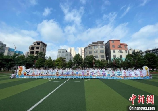 圖為學生們展示剛完成的長卷。 興業(yè)縣融媒體中心供圖