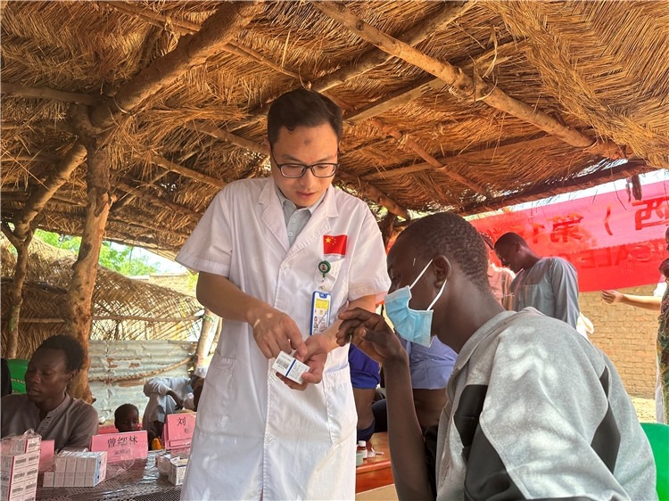 圖為南昌大學(xué)第一附屬醫(yī)院病理科主治醫(yī)師張振東為村民解說(shuō)藥品使用方法。中國(guó)駐乍得醫(yī)療隊(duì)供圖