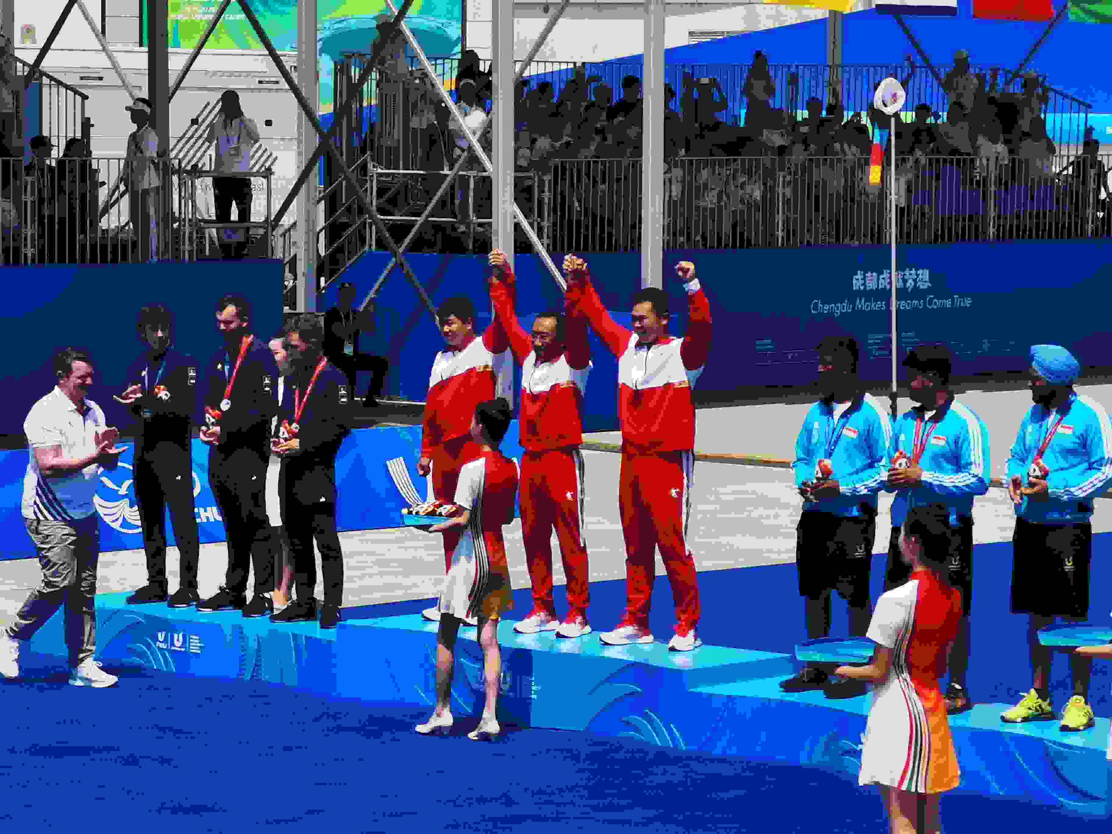 7月30日，在成都大運會男子復合弓團體頒獎儀式中，中國隊慶祝奪得冠軍。 人民網(wǎng)記者 楊磊攝