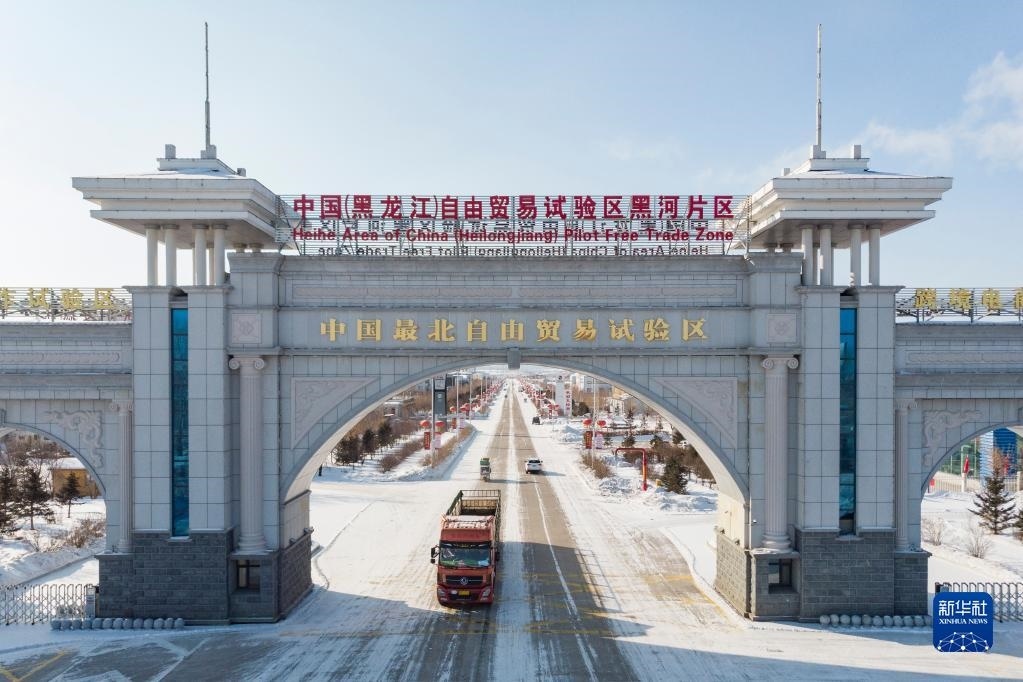 2月11日，車輛駛出中國(guó)（黑龍江）自由貿(mào)易試驗(yàn)區(qū)黑河片區(qū)大門（無(wú)人機(jī)照片）。新華社記者 謝劍飛 攝