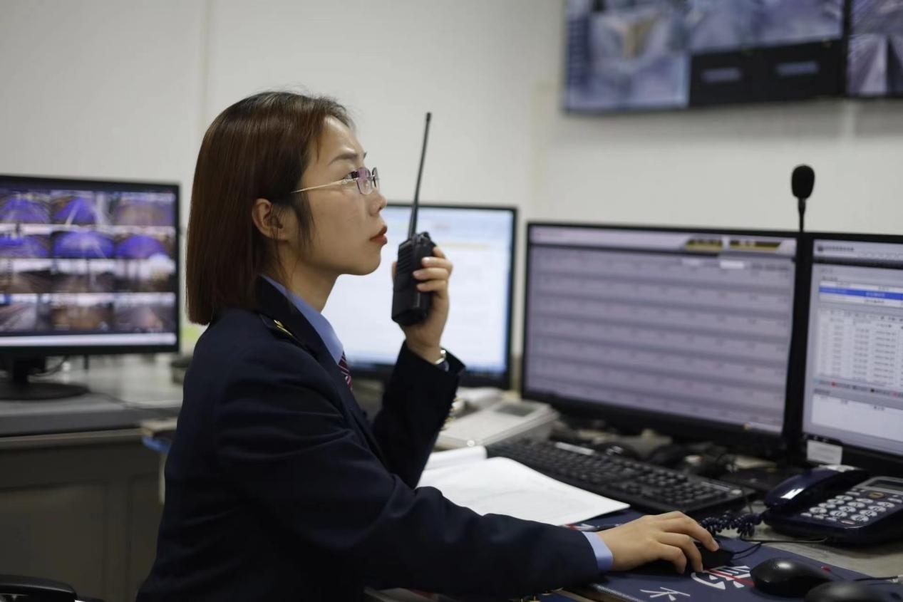 張華正在使用對講機溝通客運工作情況。蔡紫妍攝