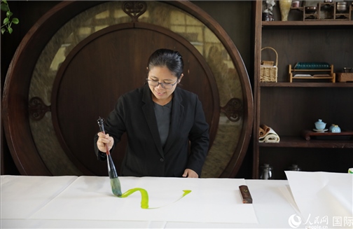 緬甸駐華大使館副館長、公使銜參贊杜欣瑪泰參加《五百筆·瀾湄合作》集體藝術(shù)創(chuàng)作。人民網(wǎng)王婧攝