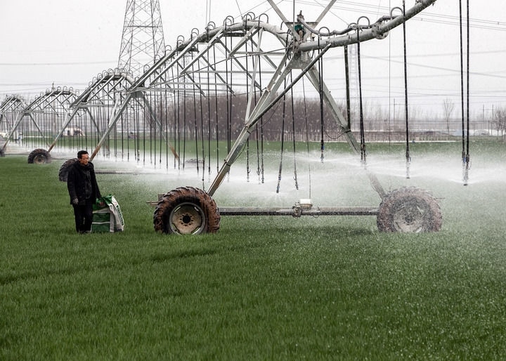 2024年3月18日，在河南省焦作市博愛縣孝敬鎮(zhèn)東原莊村瑞輝家庭農(nóng)場，村民使用全自動指針式噴灌機進行澆灌作業(yè)。新華社發(fā)（程全攝）