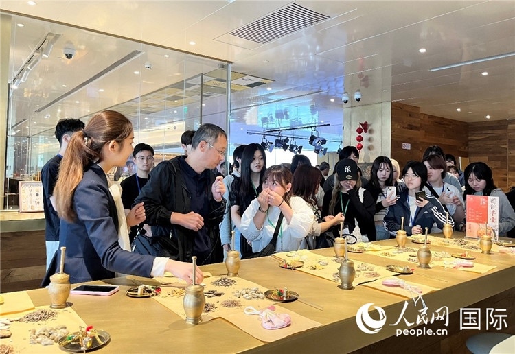 1. 日中友好協(xié)會青年代表團一行學習中醫(yī)香囊制作工序。（人民網(wǎng)記者陳思 攝）
