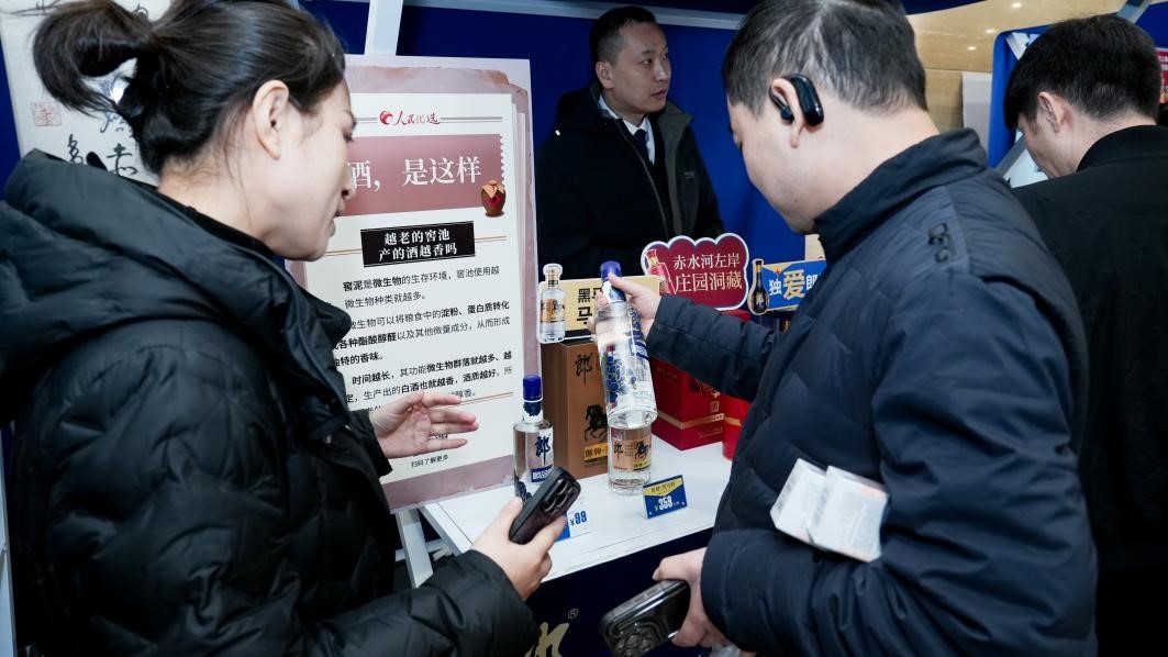 白酒展位負責(zé)人在為嘉賓介紹。張新攝