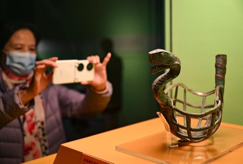 1月14日，觀眾在上海博物館蛇年迎春展拍攝展品蛇綱網(wǎng)狀銅器。新華社發(fā)（陳浩明攝）