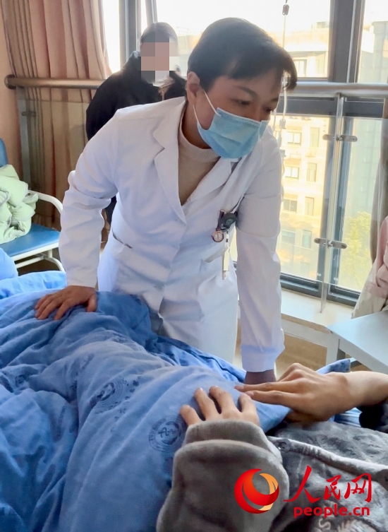 鄧茜查房時詢問患者情況。人民網(wǎng)記者 金慧慧攝