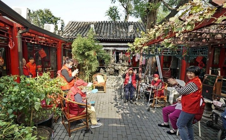 2024年10月12日，鐘樓灣胡同的老年人在社區(qū)內(nèi)的四合院養(yǎng)老驛站休閑。2017年起，北京市先后開展了兩輪背街小巷環(huán)境整治提升行動，完整保留了中軸線生活建筑群的歷史信息，并根據(jù)居民的生活和居住方式進行適配化的更新和改造，極大地改善了生活環(huán)境。2023年鐘樓灣胡同被評為“北京最美街巷”。