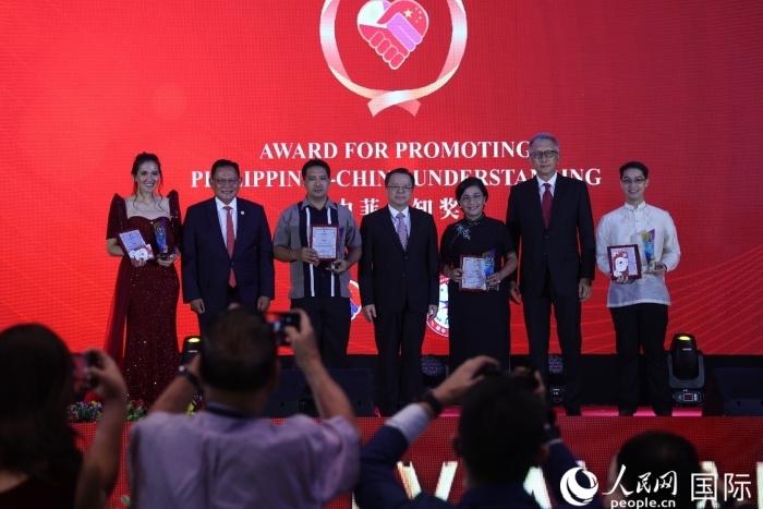 黃溪連大使和菲中了解協(xié)會主席與榮獲“友誼獎”的獲獎?wù)吆嫌傲裟睢Ｈ嗣窬W(wǎng)記者 樊帆攝